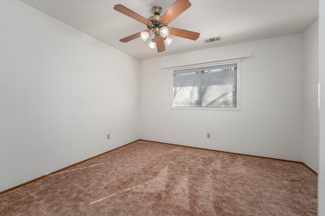 spare room featuring carpet floors and ceiling fan