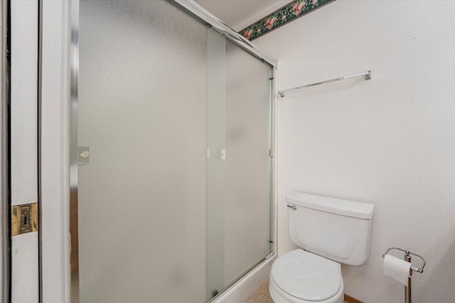 bathroom featuring toilet and an enclosed shower