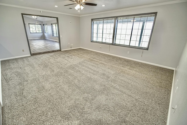 carpeted spare room with ceiling fan, ornamental molding, and lofted ceiling