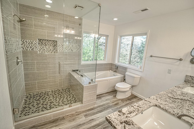 full bathroom featuring toilet, vanity, shower with separate bathtub, and hardwood / wood-style flooring