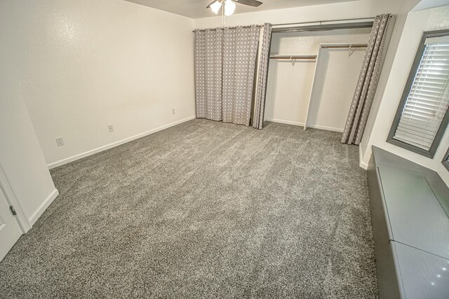 unfurnished bedroom featuring ceiling fan, carpet, and a closet