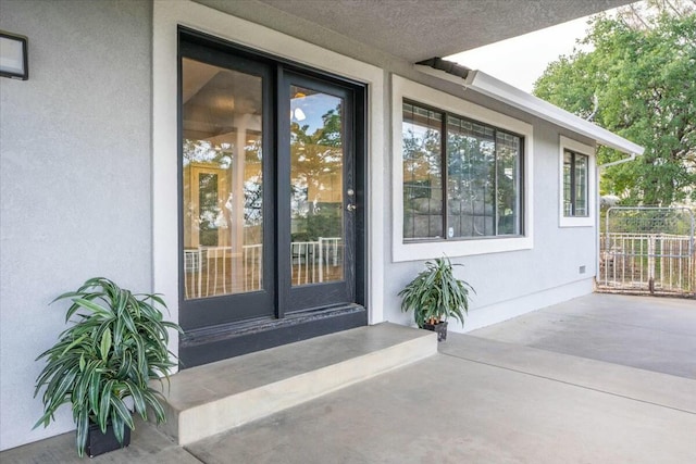 property entrance featuring a patio area