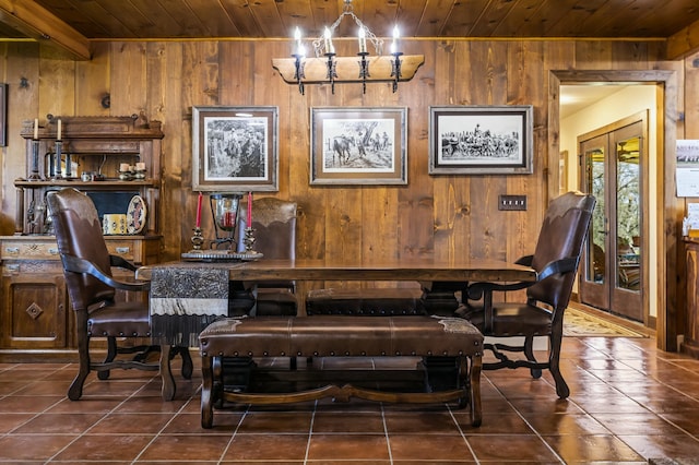 dining space with an inviting chandelier, wooden walls, beam ceiling, and wood ceiling