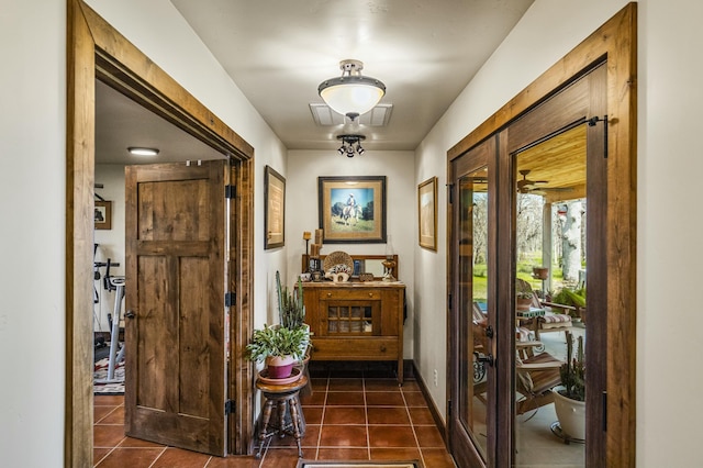 doorway to outside featuring dark tile patterned flooring