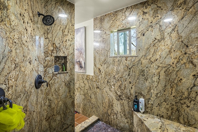 bathroom with a tile shower