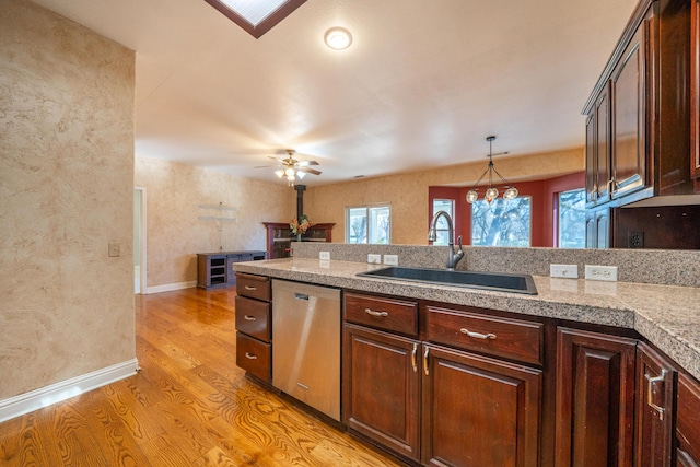 kitchen featuring sink, light hardwood / wood-style flooring, dishwasher, hanging light fixtures, and dark brown cabinetry