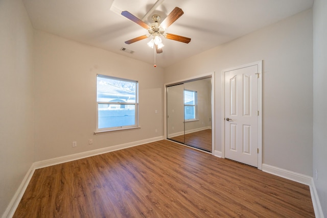 unfurnished bedroom with dark wood-type flooring and ceiling fan