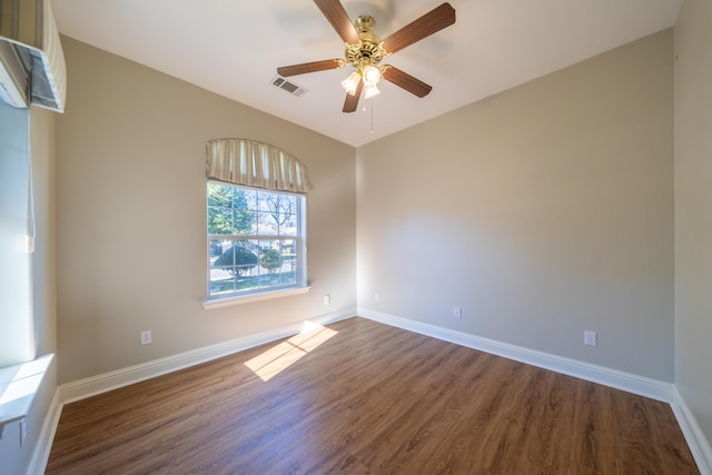 spare room with dark hardwood / wood-style floors and ceiling fan