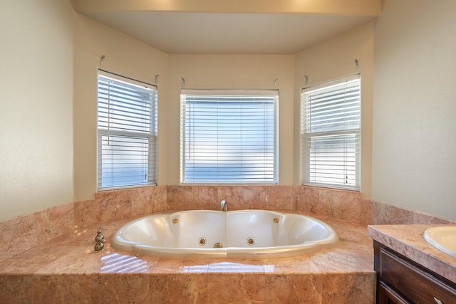 bathroom with vanity and tiled bath