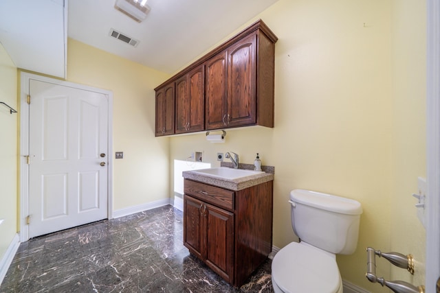 bathroom featuring vanity and toilet