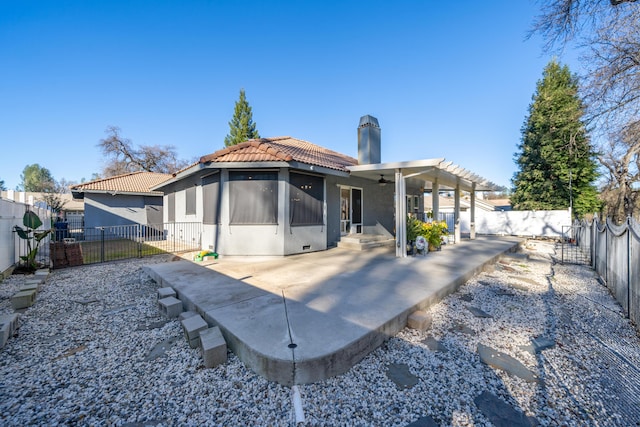 back of house with ceiling fan and a patio