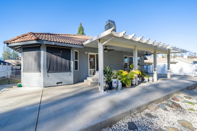 view of front of house with ceiling fan and a patio