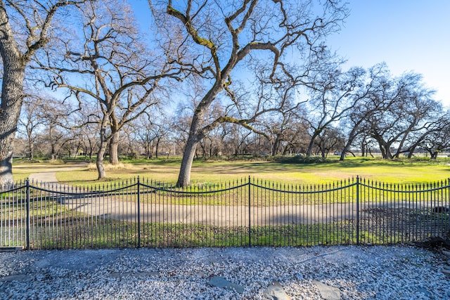 view of gate with a yard