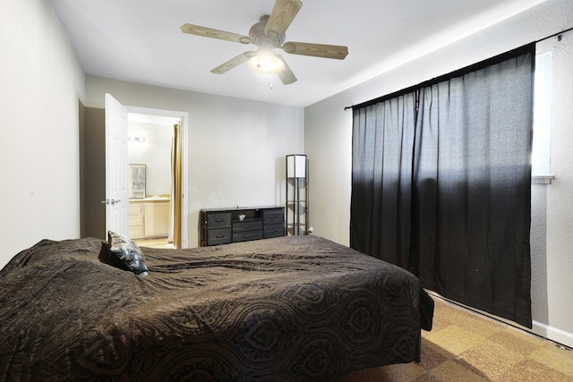 carpeted bedroom with ceiling fan and ensuite bath