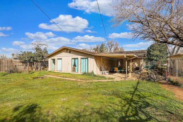 rear view of house featuring a yard