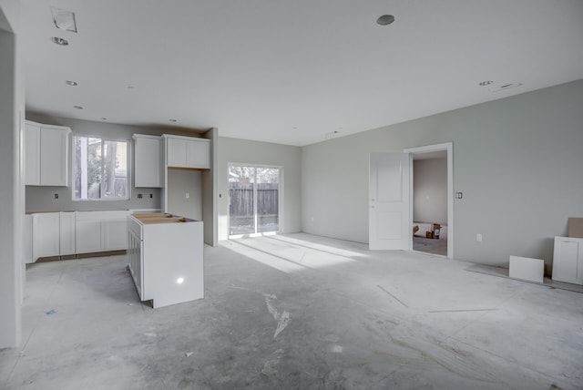 kitchen featuring a center island, white cabinetry, and a wealth of natural light