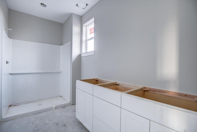 bathroom featuring concrete floors and a shower