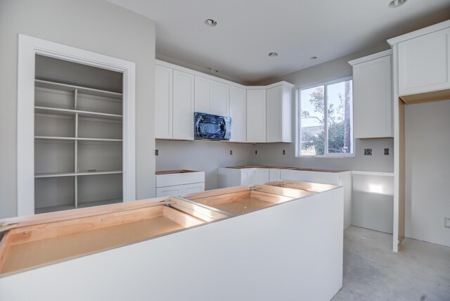 kitchen featuring white cabinetry