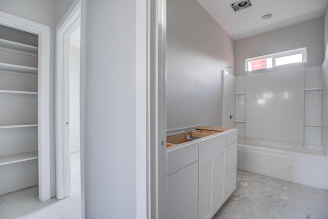 bathroom with vanity, shower / tub combination, and concrete floors