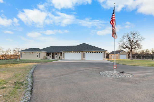 ranch-style home featuring a garage and a front yard