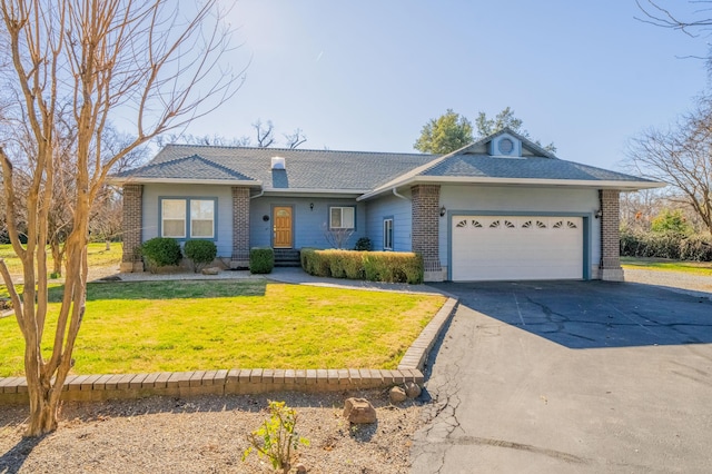 ranch-style home with a garage and a front lawn