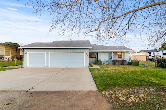 ranch-style house with a carport, a garage, and a front lawn