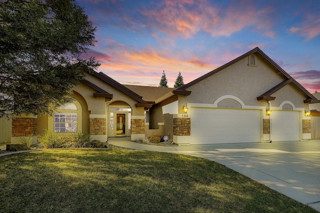 view of front of house with a yard and a garage