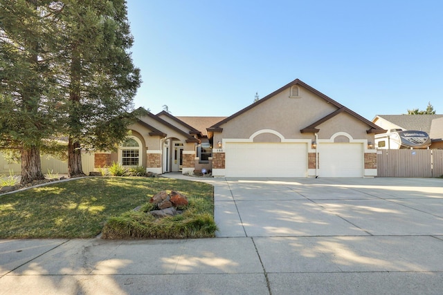 single story home featuring a garage and a front yard