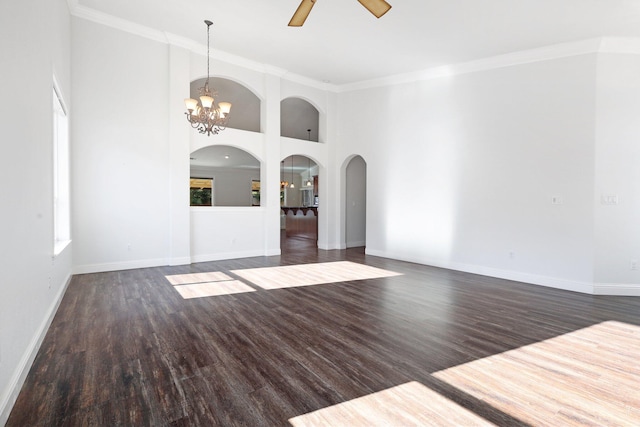 unfurnished living room with dark hardwood / wood-style flooring, ceiling fan with notable chandelier, ornamental molding, and a towering ceiling