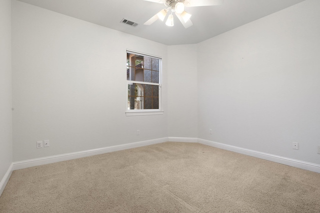 empty room with ceiling fan and carpet flooring