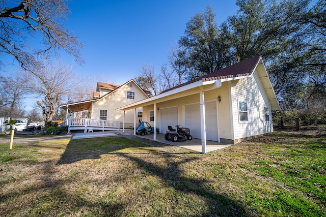 exterior space featuring a garage and a lawn