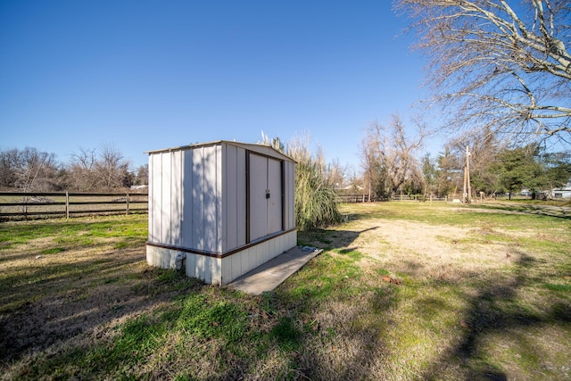 view of outbuilding featuring a lawn and a rural view