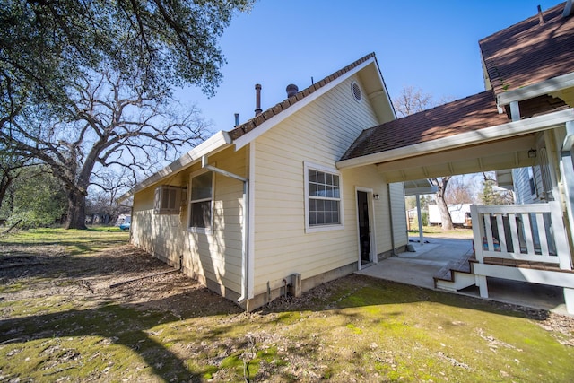 rear view of house with a patio and a lawn