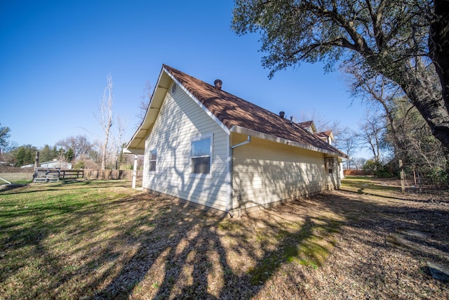 view of side of property featuring a yard