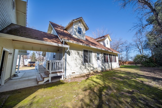 rear view of property with a yard and a patio area