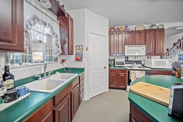 kitchen featuring white appliances and sink