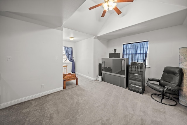 sitting room with ceiling fan, light colored carpet, and lofted ceiling