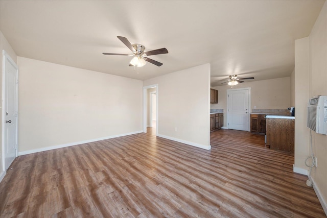 unfurnished living room featuring ceiling fan and light wood-type flooring