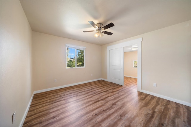 unfurnished room with hardwood / wood-style floors and ceiling fan