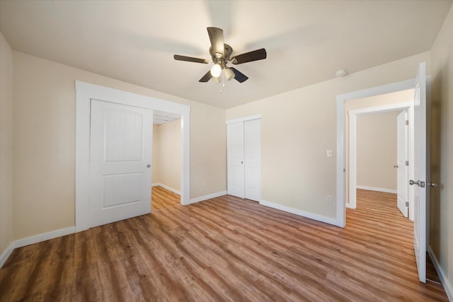 unfurnished bedroom with ceiling fan, a closet, and light wood-type flooring