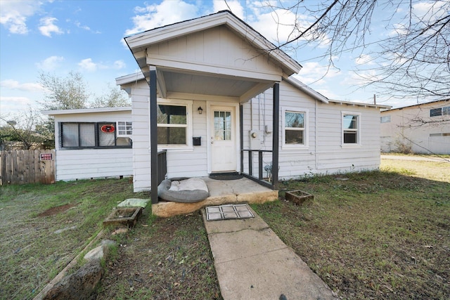 bungalow-style home with a front yard