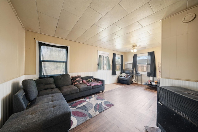 living room featuring hardwood / wood-style flooring and wood walls