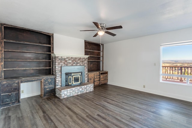 unfurnished living room featuring built in shelves, ceiling fan, and dark hardwood / wood-style flooring