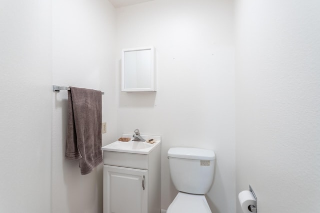 bathroom with toilet and vanity