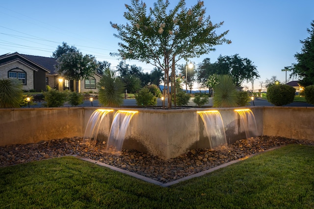 pool at dusk with a lawn