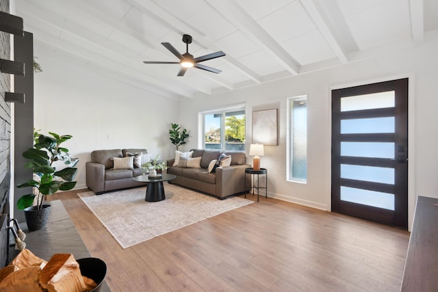 living room featuring beamed ceiling, ceiling fan, and light hardwood / wood-style flooring