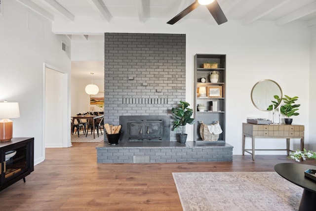 living room with beamed ceiling, ceiling fan, and hardwood / wood-style flooring