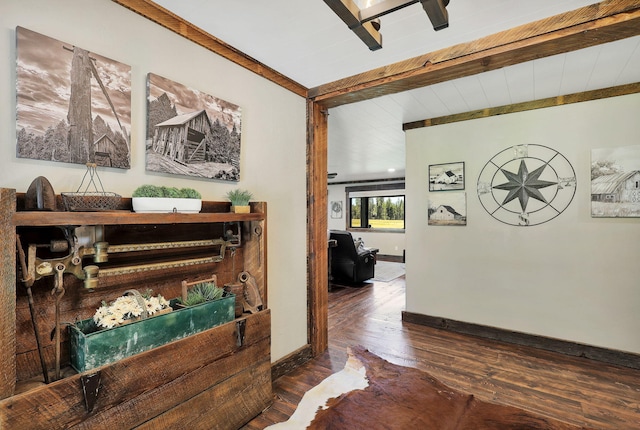 hallway featuring beam ceiling and dark hardwood / wood-style flooring