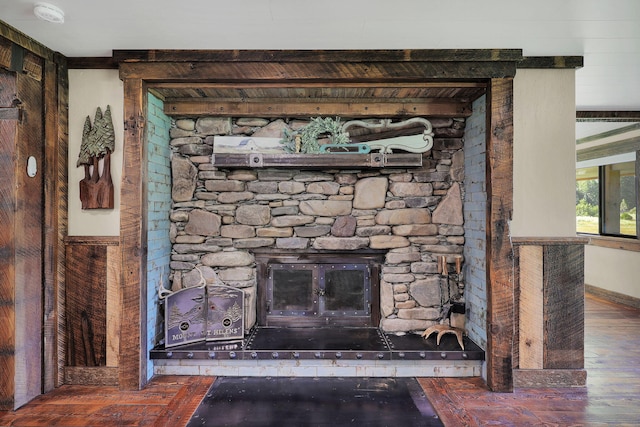 interior details featuring a stone fireplace and hardwood / wood-style flooring