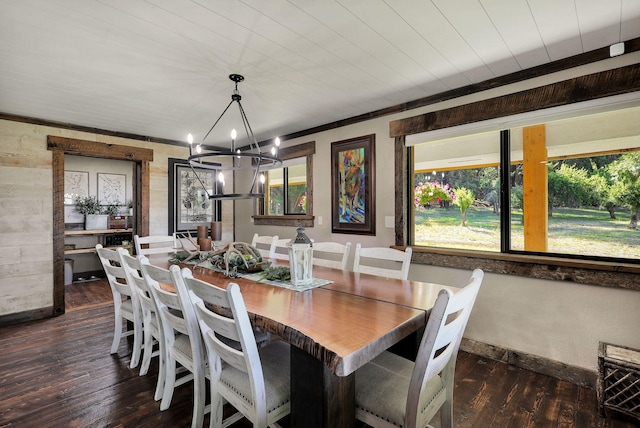 dining space with an inviting chandelier, dark wood-type flooring, and ornamental molding